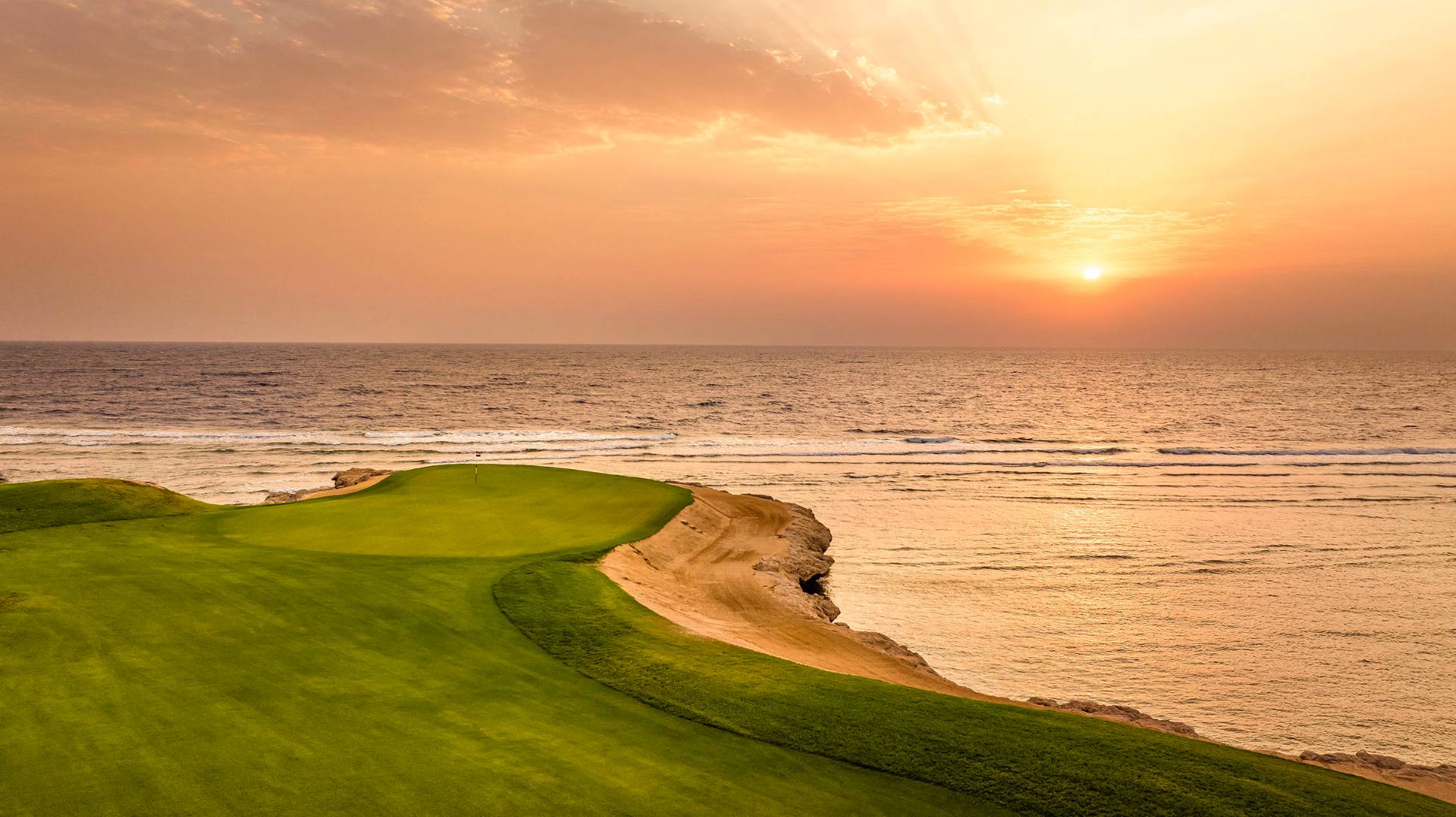 Somabay golf green beside the Red Sea at sunset